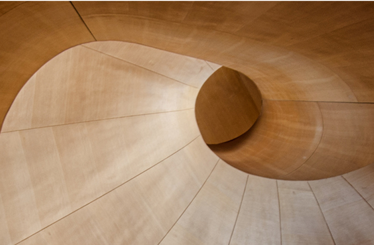 Curved wooden staircase with smooth, modern design